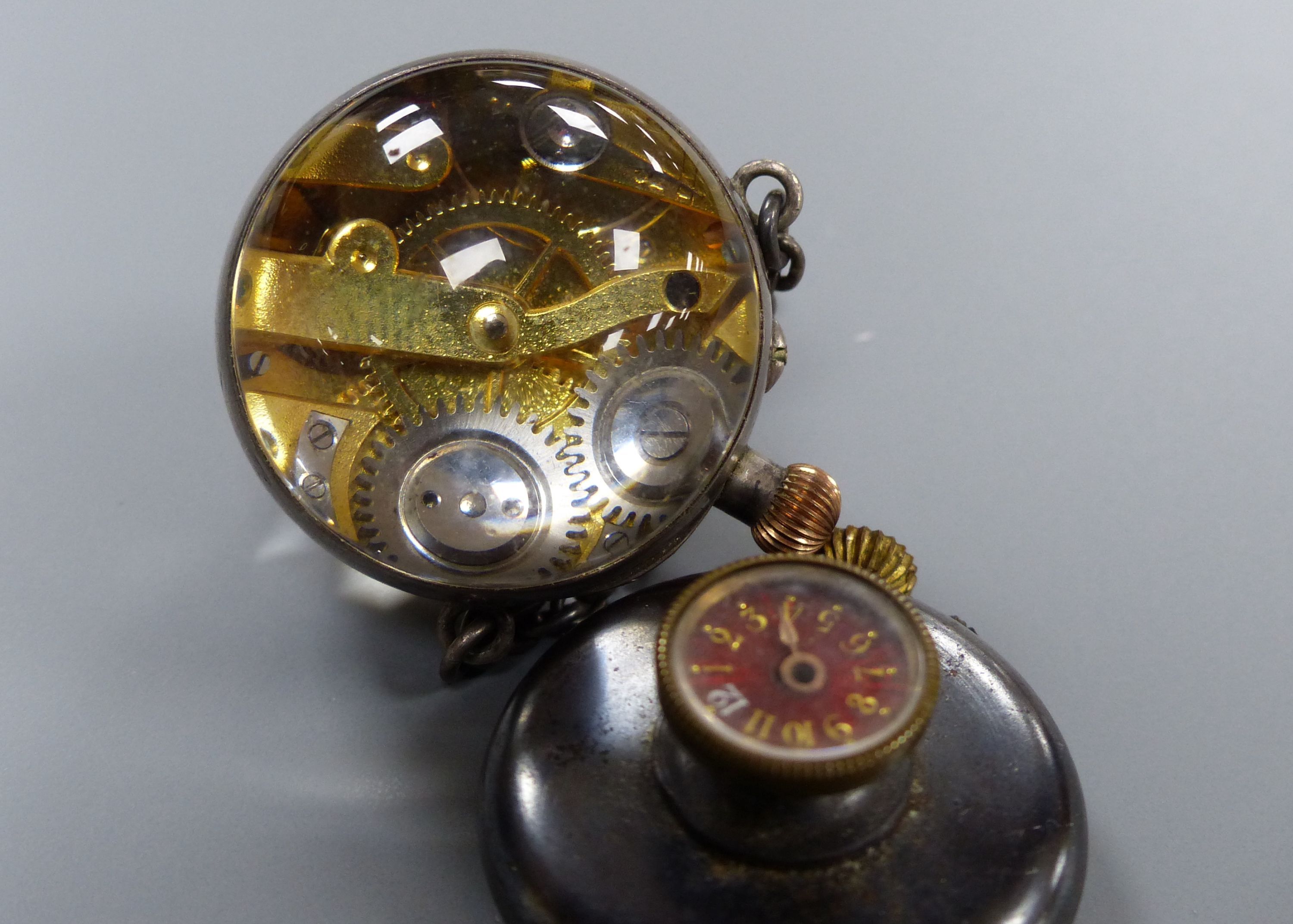 Two watches including gun metal and globe.